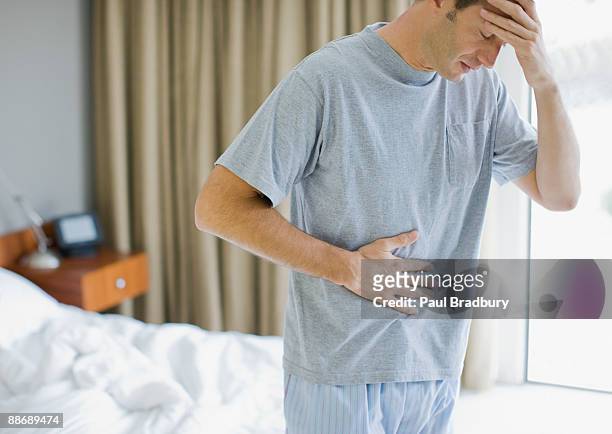 man with stomachache and headache - abdomen stock pictures, royalty-free photos & images
