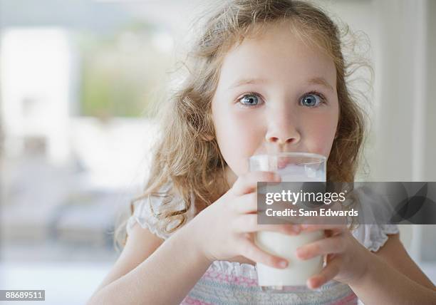 girl drinking glass of milk - sam day stockfoto's en -beelden