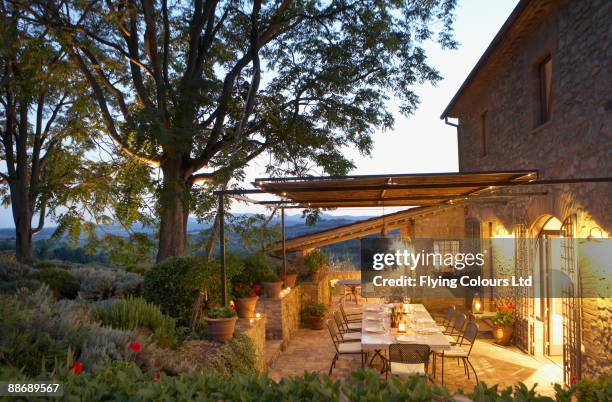 elegant table set on patio, umbria, italy - patio lights stock-fotos und bilder