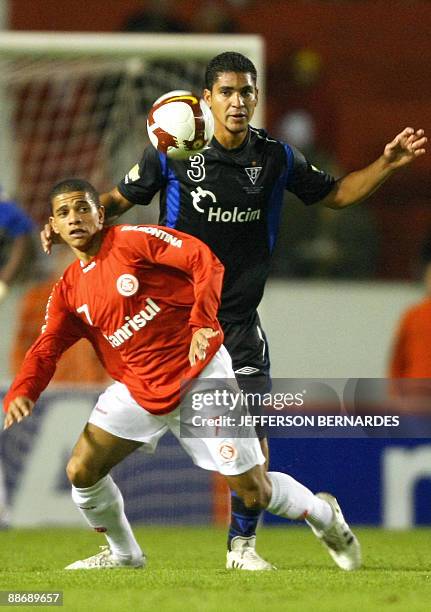 Brazil's Internacional footballer Taison vies for the ball with Ecuador's Liga de Quito Renan Calle during their 2009 Recopa Sudamericana football...