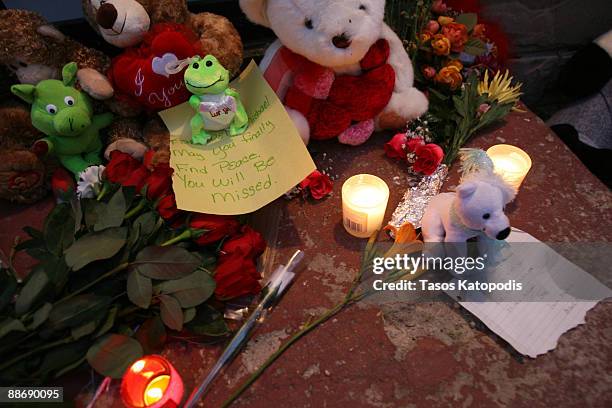Candles, notes and stuffed animals are displayed as people gather outside the former childhood home of Pop Star Michael Jackson on June 25, 2009 in...