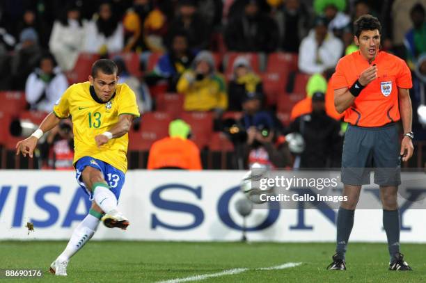 Daniel Alves of Brazil scores a free kick with only six minutes to go while referee Massimo Busacca looks on during the 2009 Confederations Cup...