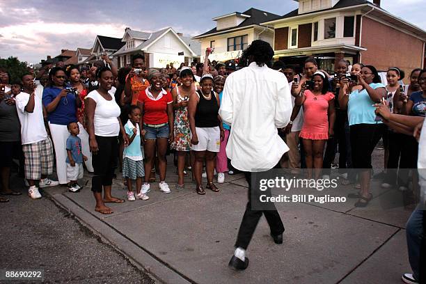 Man dressed as Michael Jackson dances for the fans who turned out to pay their respects at the Motown Historical Museum "Hitsville U.S.A" June 25,...