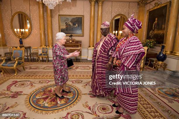 Britain's Queen Elizabeth II greets Nigeria's ambassador to the United Kingdom, George Adesola Oguntade , and his wife, Modupe Oguntade, during a...