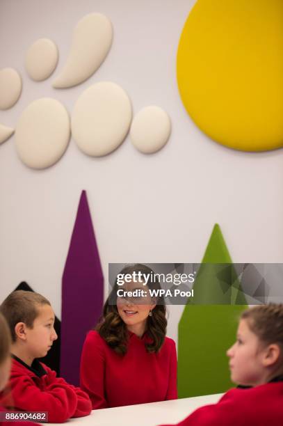 Catherine, Duchess of Cambridge speaks to children as she meets school children during a 'Stepping Out' session at MediaCityUK on December 6, 2017 in...