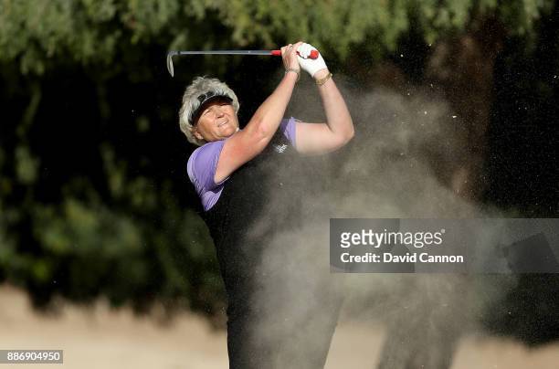 Laura Davies of England plays her second shot on the par 4, 14th hole during the first round of the 2017 Dubai Ladies Classic on the Majlis Course at...