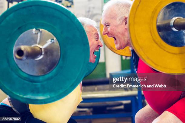 two senior powerlifters face to face, shouting - senior hobbies stock pictures, royalty-free photos & images