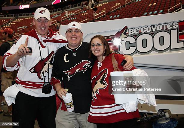 Fans of the Phoenix Coyotes pose together for a photo near a zamboni during an open house at Jobing.com Arena on June 25, 2009 in Glendale, Arizona.
