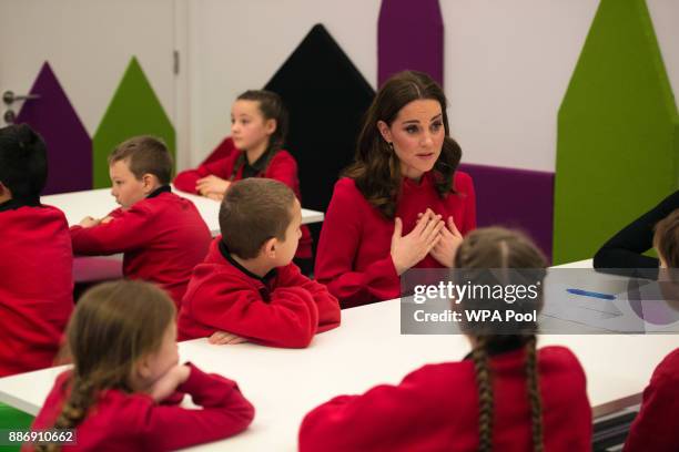 Catherine, Duchess of Cambridge speaks to children as she meets school children during a 'Stepping Out' session at MediaCityUK on December 6, 2017 in...