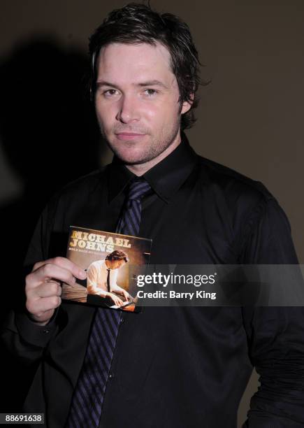 Singer Michael Johns signs his new CD at Hollywood and Highland on June 25, 2009 in Hollywood, California.