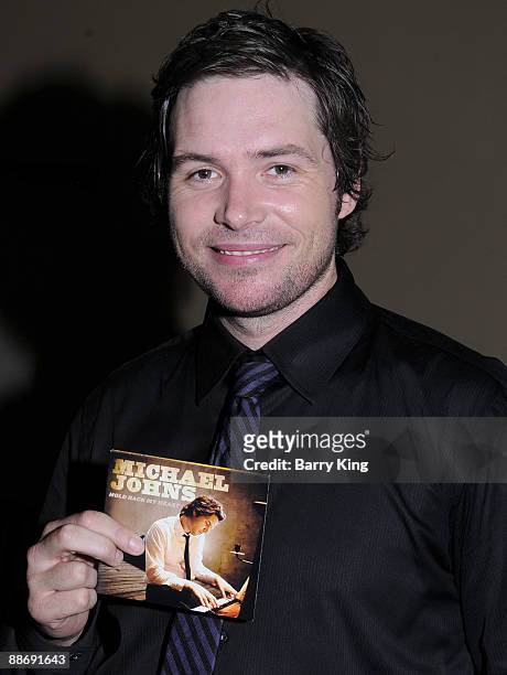 Singer Michael Johns signs his new CD at Hollywood and Highland on June 25, 2009 in Hollywood, California.