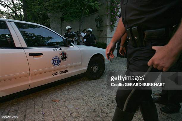 Coroner's car enters the residence of Michael Jackson following the death of the US pop icon on June 25, 2009 in Los Angeles California. Jackson died...