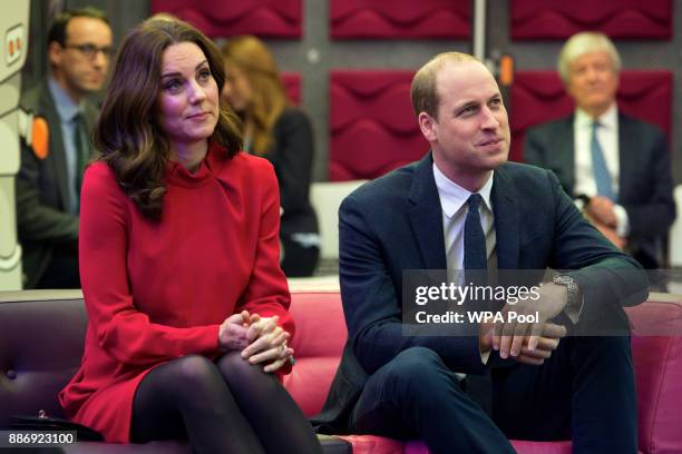 Prince William, Duke of Cambridge and Catherine, Duchess of Cambridge listen to a presentation before speaking to school children taking part in a...