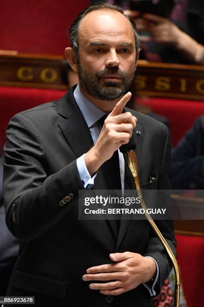 French Prime Minister Edouard Philippe addresses deputies during a session of questions to the government on December 6, 2017 at the National...