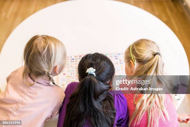 girls (8-9) reading book together - endast flickor bildbanksfoton och bilder