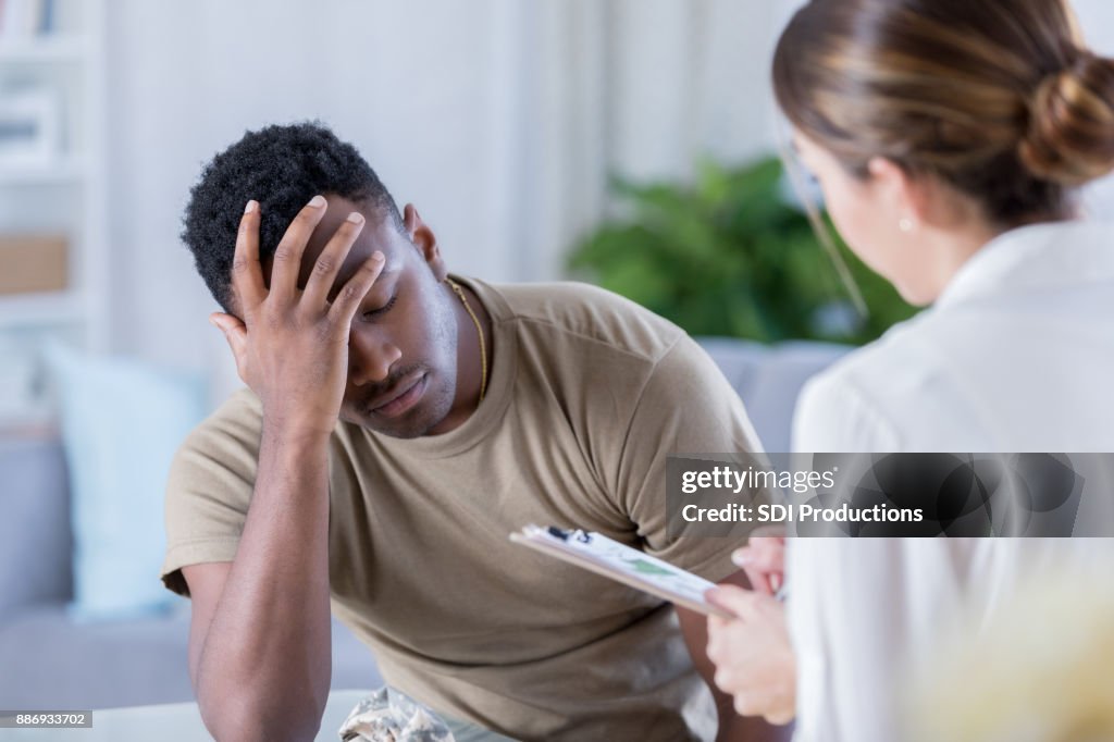 Upset soldier talks with therapist