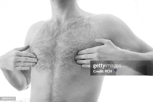 young man covering nipples - brustwarze stock-fotos und bilder