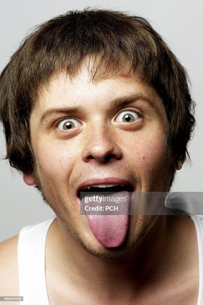 Young man sticking his tongue out