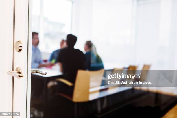 colleagues talking during business meeting - close door stock pictures, royalty-free photos & images