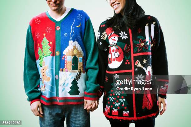 christmas sweater couple - ugliness stock pictures, royalty-free photos & images