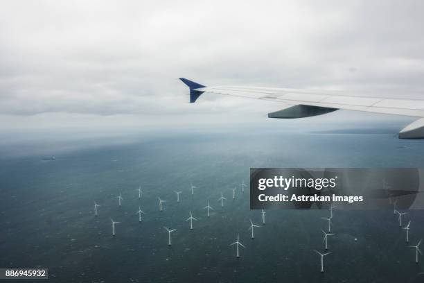 aerial view of foggy field with wind turbines - luftfahrzeug stock-fotos und bilder