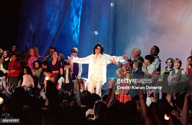 Michael Jackson performs on stage with children at the Brit Awards at Earls Court on February 19th 1996 in London