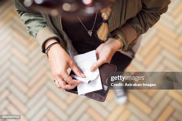 woman holding open wallet with banknotes and receipts - lady wallet stock-fotos und bilder