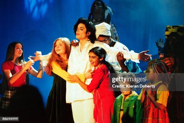 Michael Jackson performs on stage with children at the Brit Awards at Earls Court on February 19th 1996 in London