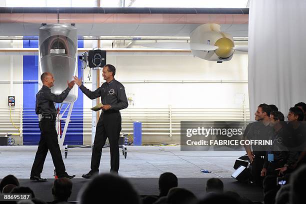 Swiss scientist-adventurer and pilot Bertrand Piccard and Solar Impulse CEO Andre Borschberg unveil the 'Solar Impulse' during a ceremony on June 26,...