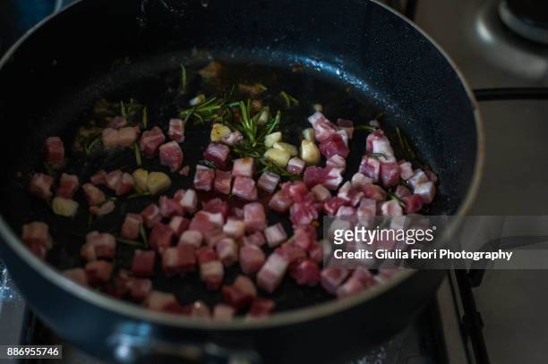 pancetta and rosemary in a pan - pancetta stock pictures, royalty-free photos & images