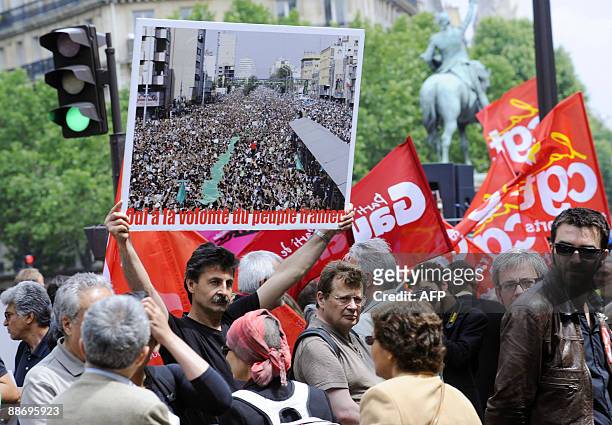 People demonstrate to protest against Iranian President Mahmoud Ahmadinejad's disputed re-election, on June 26, 2009 in Paris, near Iranian embassy....