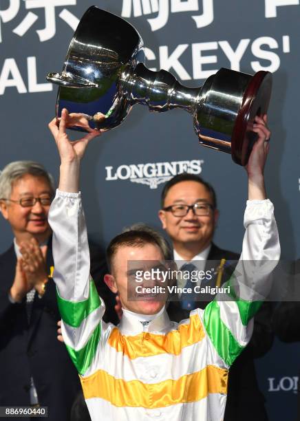 Zac Purton poses with the trophy after winning Jockeys championship during Longines Hong Kong International Jockey Championship at Happy Valley...