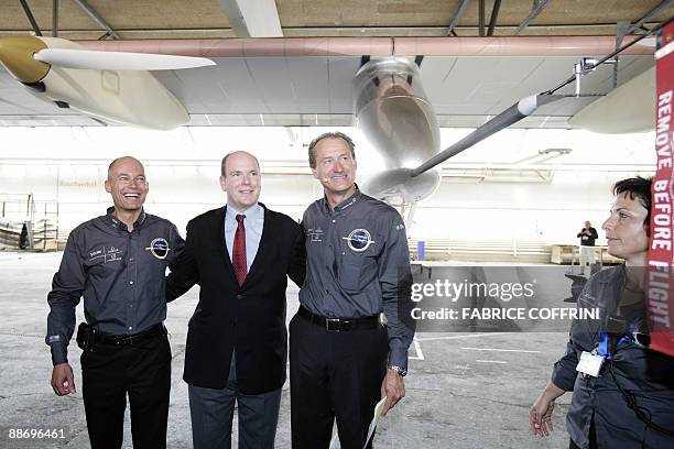 Swiss scientist-adventurer and pilot Bertrand Piccard and Solar Impulse CEO Andre Borschberg pose with Prince Albert II of Monaco after the 'Solar...