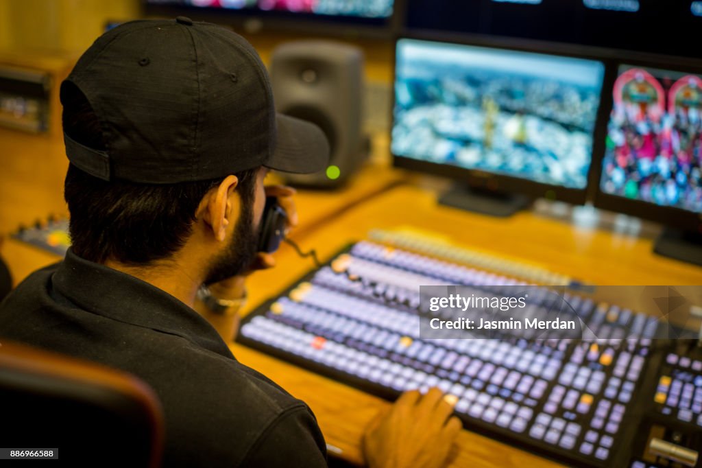 TV editor working with vision mixer in television broadcast gallery