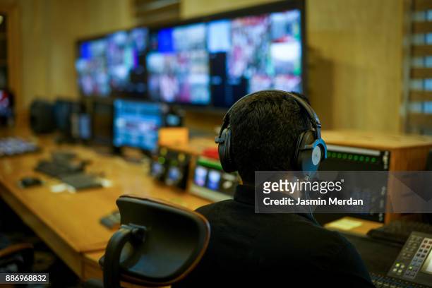 tv editor working with vision mixer in television broadcast gallery - executive producer stockfoto's en -beelden
