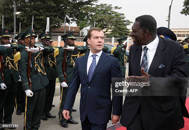 Russian President Dmitry Medvedev speaks with Angolan Foreign Minister Assuncao Afonso de Sousa dos Anjos upon his arrival in Luanda on June 26,...