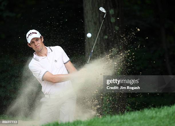 Aaron Baddeley of Australia works out of the rough during round two of the 2009 Travelers Championship at TPC River Highlands on June 26, 2009 in...