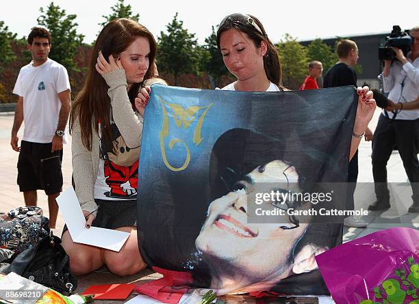 Fans gather to lay tributes to Michael Jackson outside the O2 Arena where Jackson was to perform 50 sell out nights starting next month on June 26,...