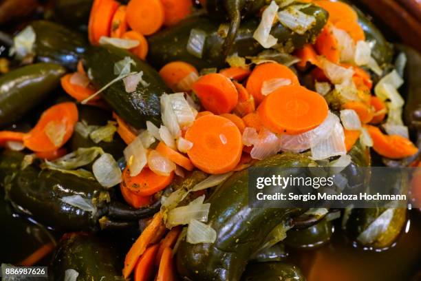 green pickled jalapenos chili peppers in a market in tlalpan - mexico city, mexico - ancho stockfoto's en -beelden