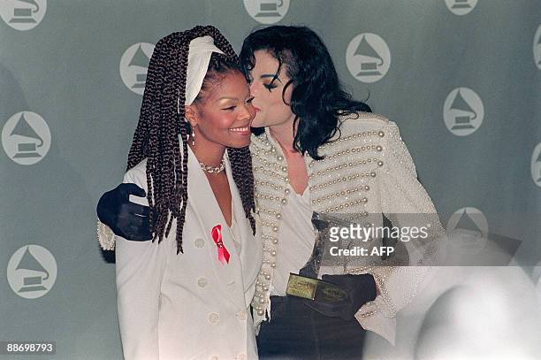Pop star and entertainer Michael Jackson kisses his sister Janet Jackson after she presented him with the Grammy Legend Award at the 35th Annual...