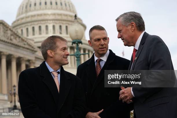 Rep. Mark Meadows talks to Rep. Jim Jordan and Rep. Scott Perry during a news conference in front of the Capitol December 6, 2017 in Washington, DC....