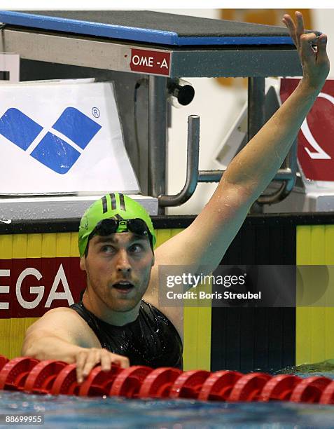 Helge Meeuw of SG Frankfurt celebrates winning the men's 50 m backstroke A final during the German Swimming Championship 2009 at the Eurosportpark on...