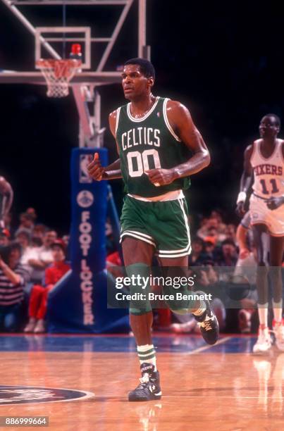 Robert Parish of the Boston Celtics runs up the court during an NBA game against the Philadelphia 76ers on April 18, 1991 at the Spectrum in...