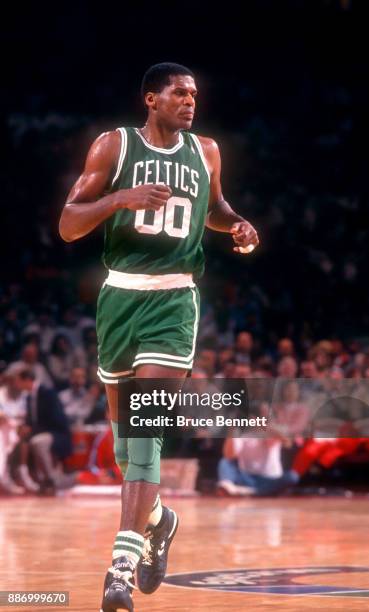 Robert Parish of the Boston Celtics runs up the court during an NBA game against the Philadelphia 76ers on April 18, 1991 at the Spectrum in...