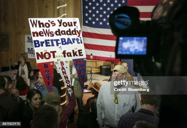 Attendees hold signs before the start of a campaign rally for Roy Moore, Republican candidate for U.S. Senate from Alabama, not pictured, in...