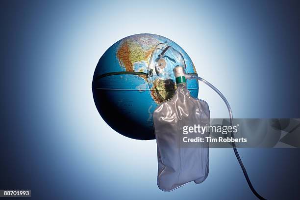 oxygen mask attached to a globe - o2 stockfoto's en -beelden