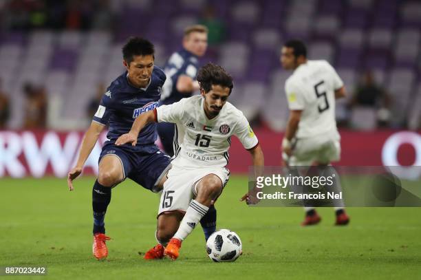 Khalfan Alrezzi of Al-Jazira is challenged by Takuya Iwata of Auckland City FC during the FIFA Club World Cup UAE 2017 play off match between Al...