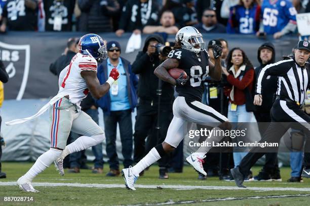 Cordarrelle Patterson of the Oakland Raiders is pursued by Landon Collins of the New York Giants at Oakland-Alameda County Coliseum on December 3,...