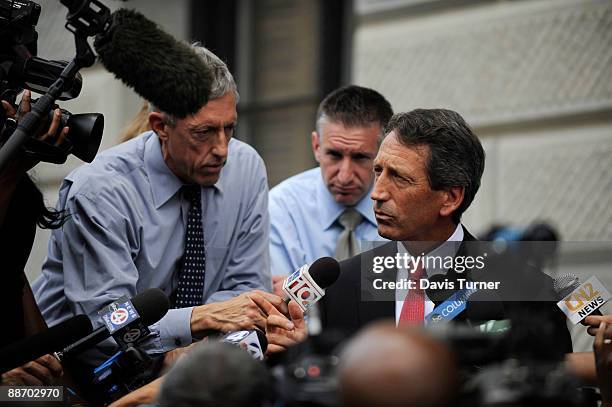 South Carolina Gov. Mark Sanford fields questions from the media outside of a side entrance of the S.C. Statehouse following a special meeting with...