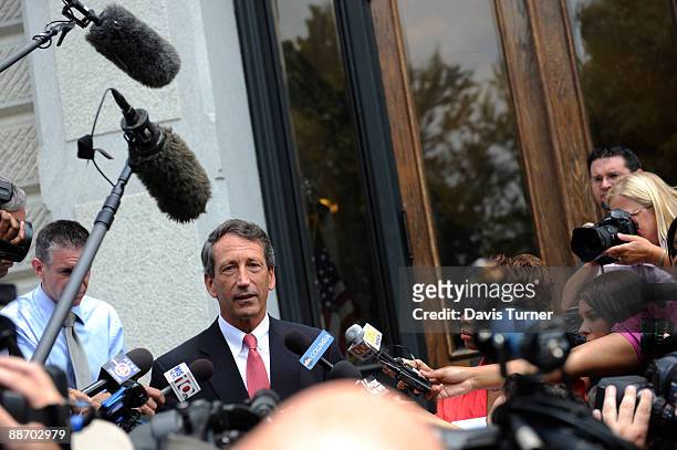 South Carolina Gov. Mark Sanford fields questions from the media outside of a side entrance of the S.C. Statehouse following a special meeting with...